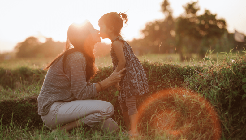 mom kissing child