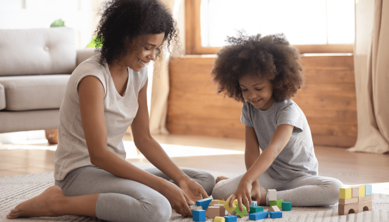 mom and child playing blocks on the floor (special time)