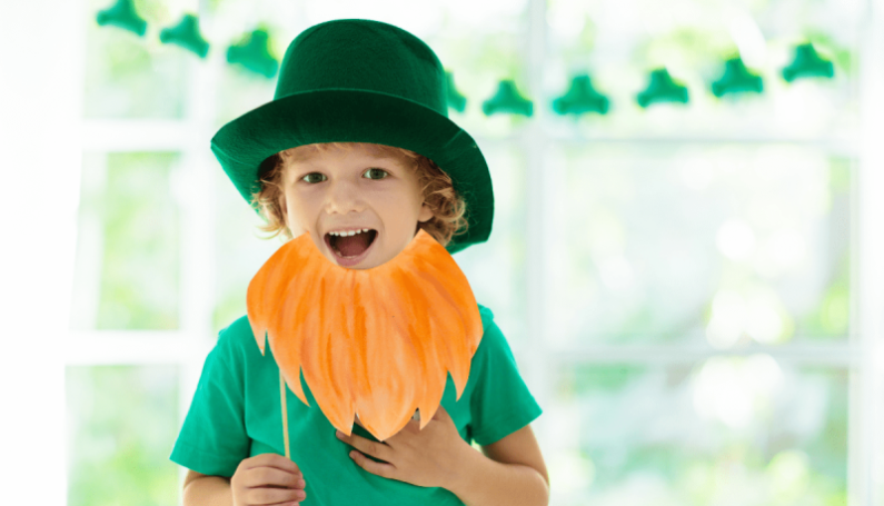 child wearing green shirt, green hat, and pretend leprechaun beard to celebrate St. Patrick's Day