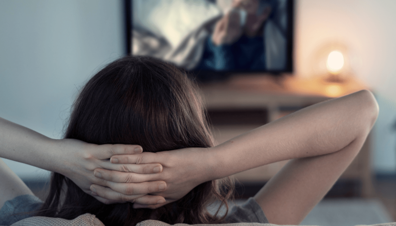 woman watching TV alone (Thanksgiving TV episodes and shows)