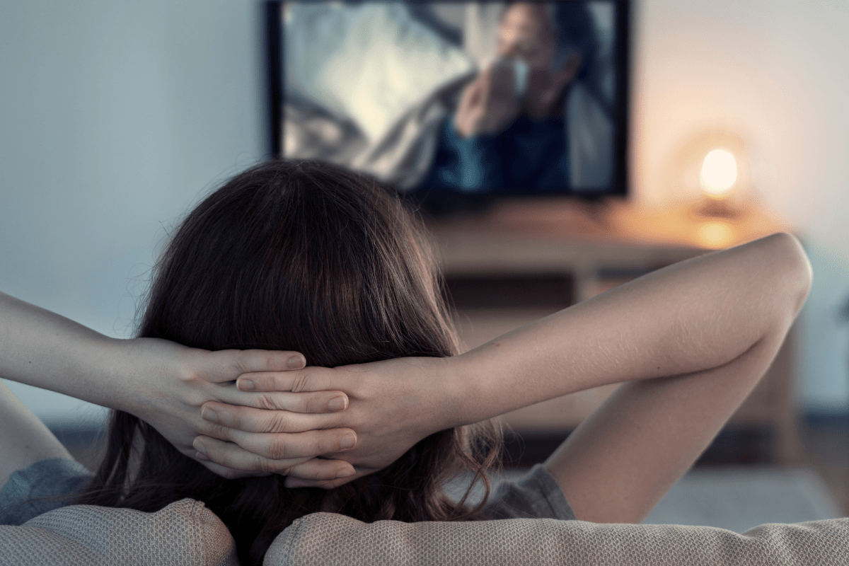woman watching TV alone (Thanksgiving TV episodes and shows)
