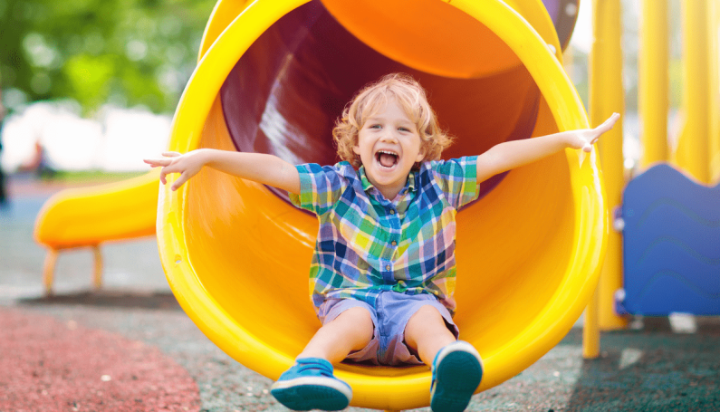 young boy on a slide, baby and toddler friendly playgrounds north of Boston