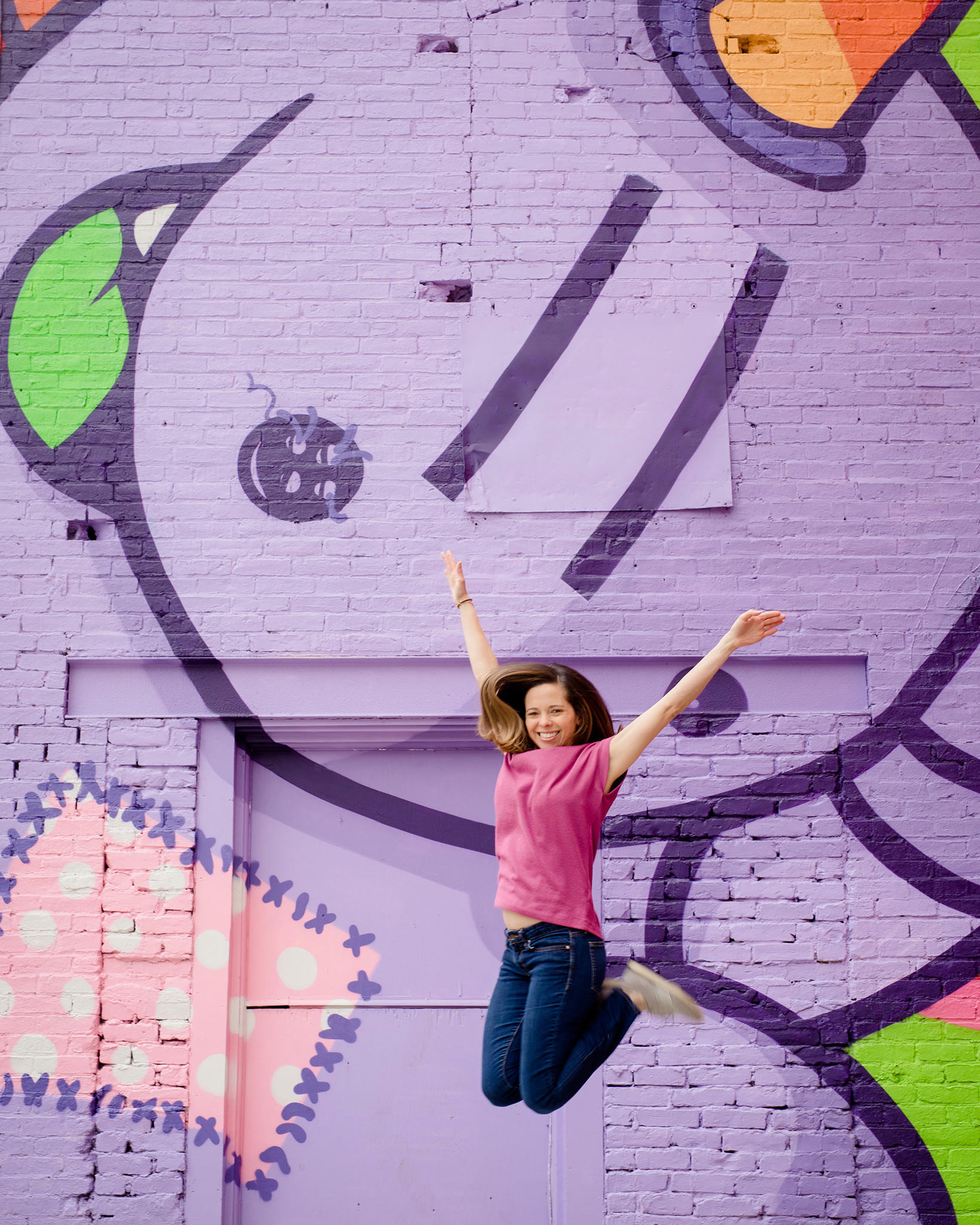 woman standing in front of mural